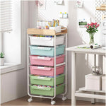 SYKIARIOL rolling storage cart with drawers, six-drawer pastel rainbow version in a craft room by a window
