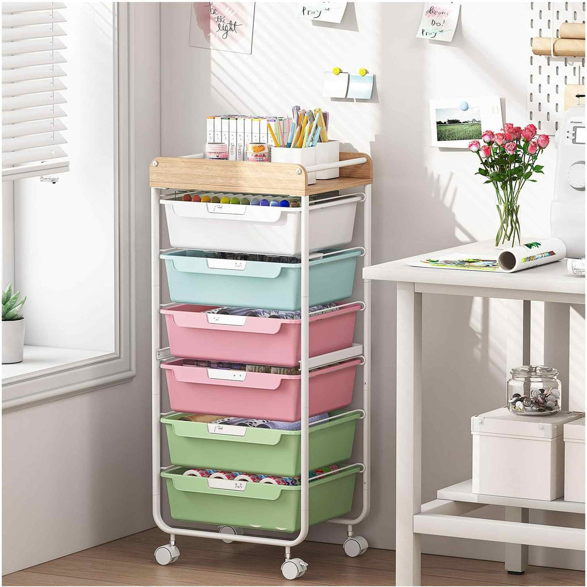 SYKIARIOL rolling storage cart with drawers, six-drawer pastel rainbow version in a craft room by a window