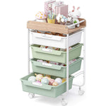 SYKIARIOL rolling storage cart with drawers, four-drawer version with white and green drawers holding decorated eggs