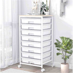 SYKIARIOL 8-drawer rolling storage cart, white drawers beside a plant