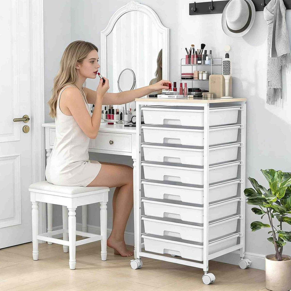 SYKIARIOL 8-drawer rolling storage cart – beside a vanity where a woman applies makeup