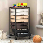 SYKIARIOL 8-drawer rolling storage cart, cream and brown gradient drawers on a black frame with toys on top
