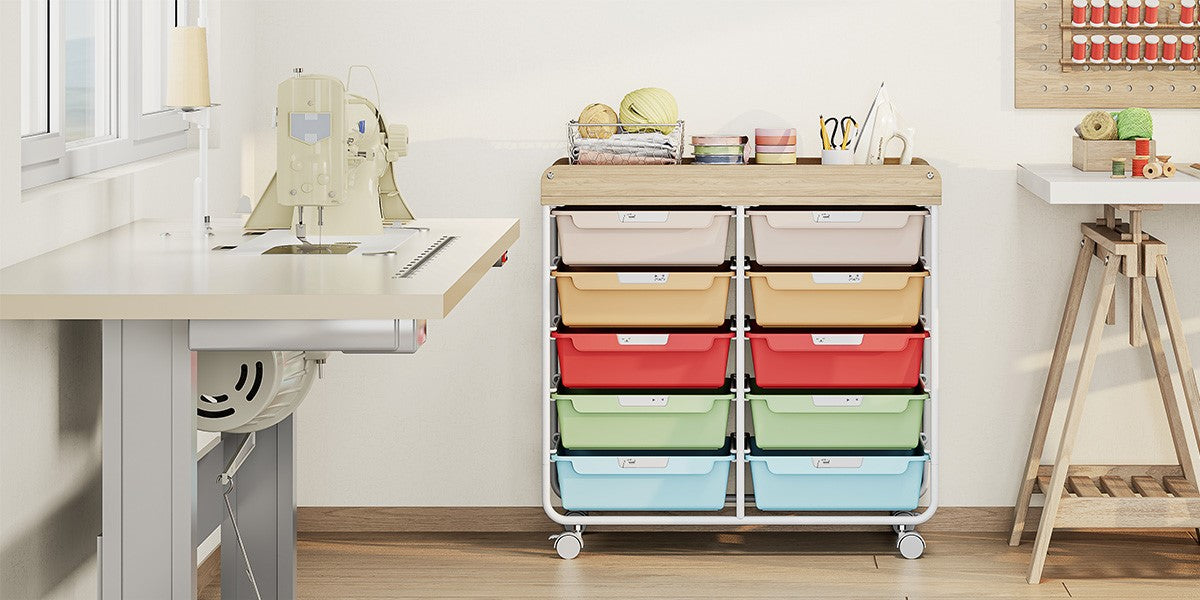 Rainbow-drawer rolling storage cart next to a craft desk and sewing machine in a craft room