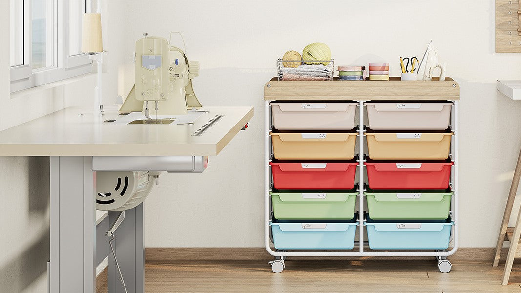 Rainbow-drawer rolling storage cart next to a craft desk and sewing machine in a craft room